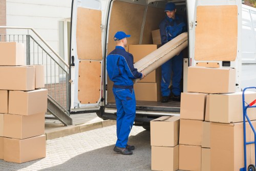 Removal team handling furniture safely during a house move in Sutton
