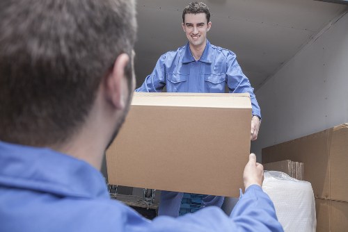 Removal team helping with a home move in Sutton residential street