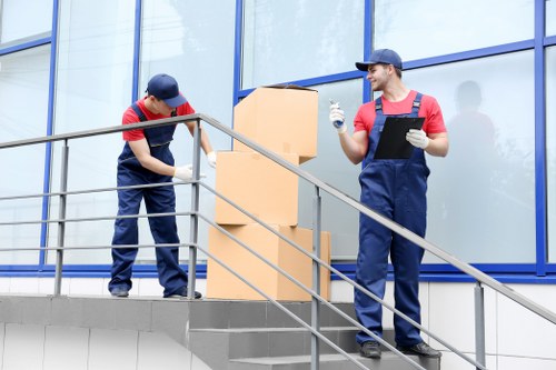 Removal staff loading furniture safely into a van