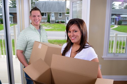 Removal crew handling items at a property entrance