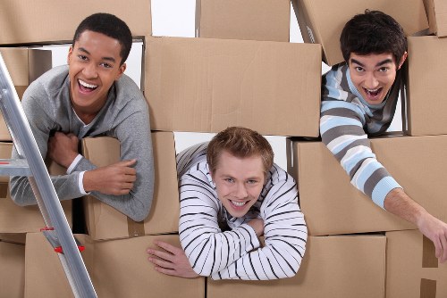 Furniture pick-up team collecting a sofa from a Sutton home