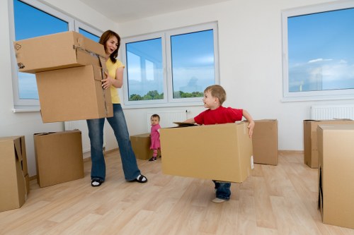 Trained movers carrying boxes with care in a Sutton removal service