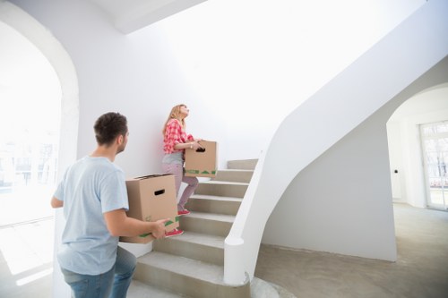 Professional movers working safely with boxes and furniture