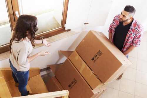 Professional movers handling furniture with care in Sutton