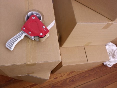 Packed moving boxes and furniture arranged for transport